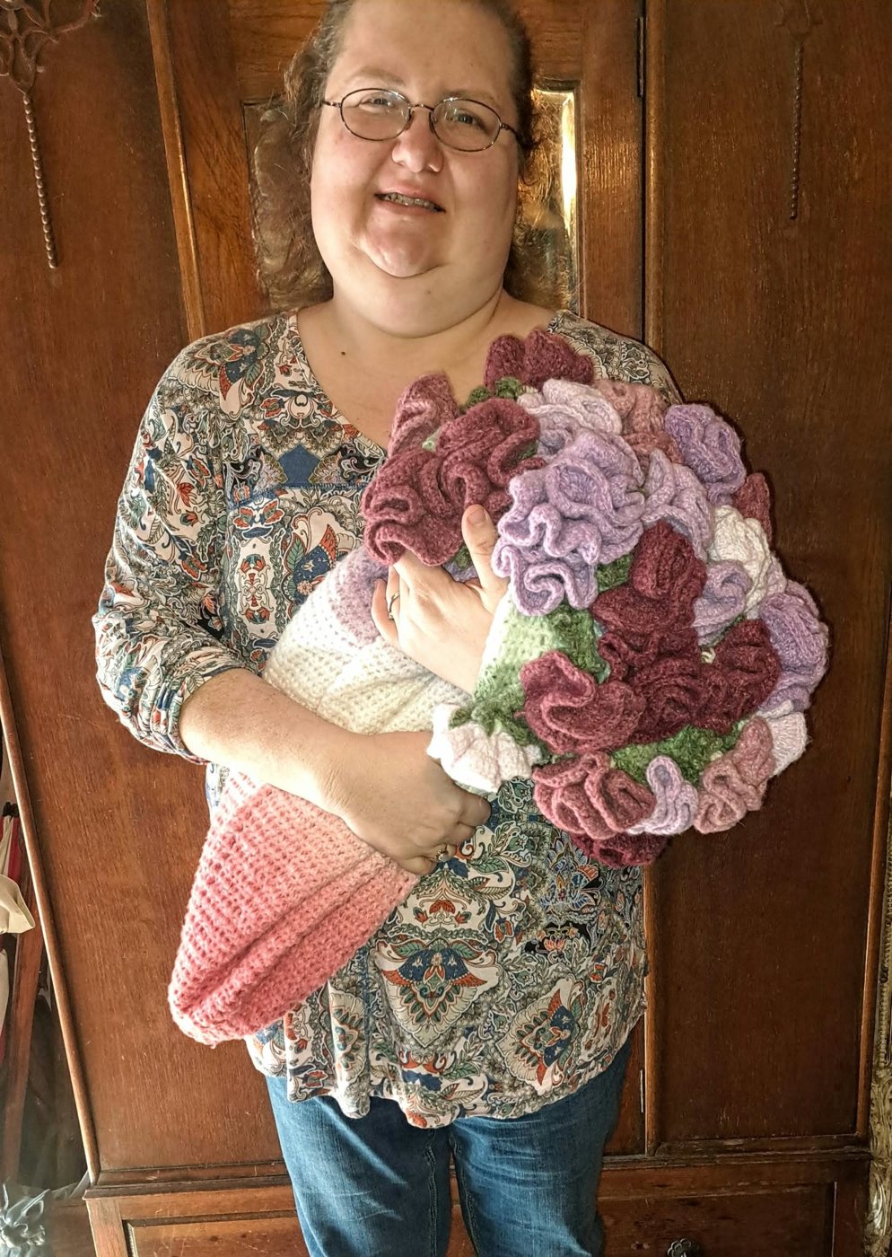 Jennifer holding the rose blanket bundled like a bouquet